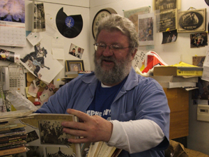 Jerry thumbs through used albums he's bought from 