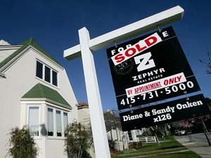 A single family home sits with a sold sign in the 