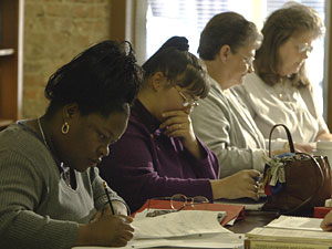 Adults putting pencil to paper 