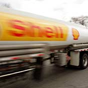 A Shell Oil tanker truck moves down a street. 