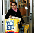 A shopper exits an Old Navy store with her ... 
