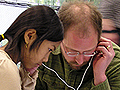 Phil Rynearson and Malenna Hoes listen together.