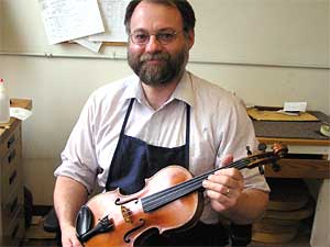 Shop manager Douglas Lay repairs violins played by musicians, music teachers and students. He began repairing instruments more than 20 years ago.