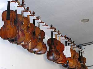 Several of these instruments date back to the 1700s. They hang near the ceiling of Andrew Dipper's workshop at Claire Givens Violins.