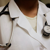 A doctor wears a stethoscope during an ... 