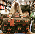 A vendor shows a bag based in one of Louis ... 