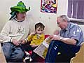 Larry Jones (r) reads to his grandson
