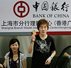 Customers leave a Bank of China branch in ... 