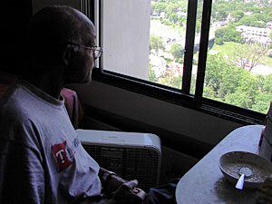 From the 20th floor of his highrise apartment, Sam looks down on the Minneapolis streets where he once lived.