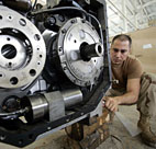 A soldier repairs an engine at a workshop at ... 