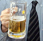 A businessman has a beer with colleagues. 