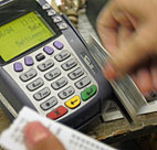 A sales associate swipes a customer's credit card. 