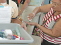 A woman puts on hand lotion