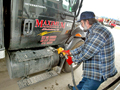 Trucker James Baker pumps fuel into his rig
