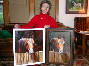 Lynn Maderich shows an original painting she did, and a copy of her work she found on the Internet. The original is on the right.
