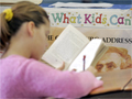 a fifth grade student  works on a book report