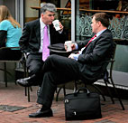 Businessmen talk at Starbucks 