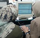 Two Iranian women work at an Internet cafe in ... 