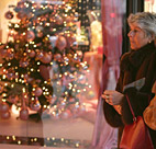 Shoppers walk by a store display window ... 
