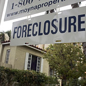 A foreclosure sign hangs in front of a home in ... 