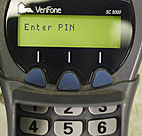 A debit machine asks for the customer's PIN number 