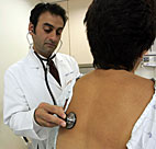 A doctor examines a patient. 