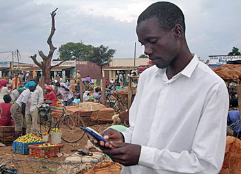 Martin Kisuya checks prices on his phone. 