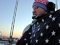 Mark Duclos folds the state capitol American flag.