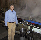 Maple Syrup farmer Jon Pryor stands beside a ... 