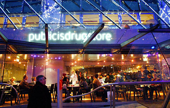 Customers sit at a cafe in the ... 