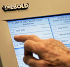 A voter uses one of Diebold's electronic touch ... 