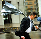 The wind blows a businessman's umbrella ... 
