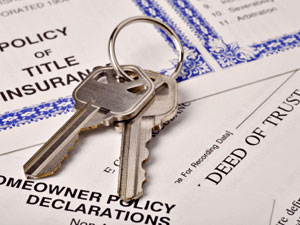 Keys laid out on the title of a new home 