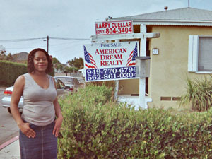 Monique Parker in front of her former home 