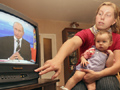 An infant watches TV