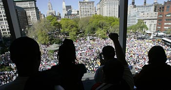 Supporters watch from the top floor windows of ... 