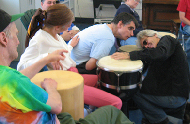 
                    Eddie Tuduri gets down, literally, with a student at the Ojai Enrichment Center for developmentally disabled adults.
                                            (Pat Loeb)
                                        