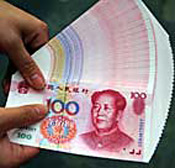 A Chinese vendor displays notes during a cash ... 