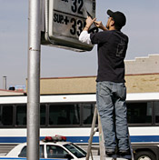 A worker manually changes gas prices at the ... 