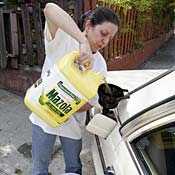 Tracy Larkin of Los Angeles fills the tank of ... 