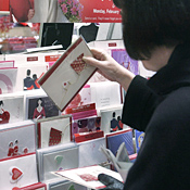 A woman shops for greeting cards. 