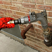 A worker pumps heating oil into a home. 