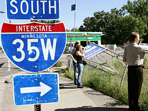 People take pictures of a section of the I-35W bridge that collapsed in Minneapolis.