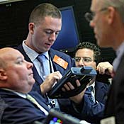 Traders work on the floor of the New York ... 