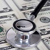 Stethoscope lying on money 