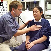 Dr. Michael Paul performs a physical exam on a ... 