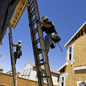 Construction workers build new homes in San ... 