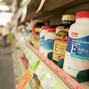 Vitamins sit on the shelf of a CVS pharmacy. 