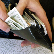 Man pulls cash from his wallet 