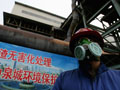 Chinese laborer works on emission system